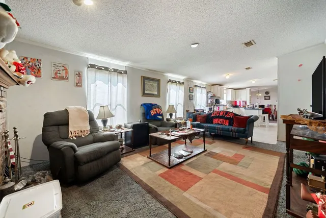 a living room with furniture a rug and a flat screen tv