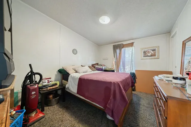 a bedroom with a bed and a tv