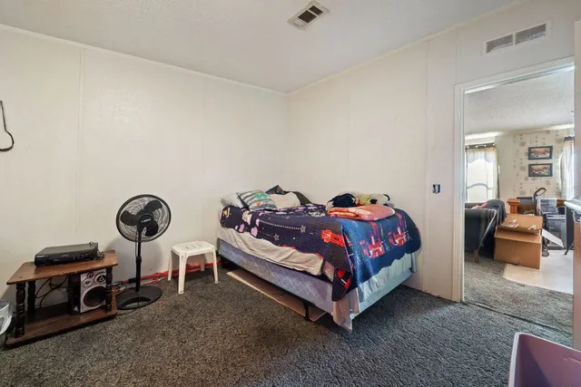 a spacious bedroom with a bed and furniture