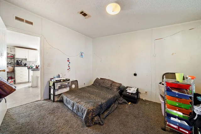 a bedroom with furniture and a book shelf