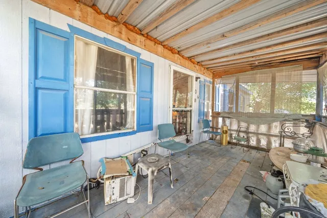 a balcony with furniture and large window