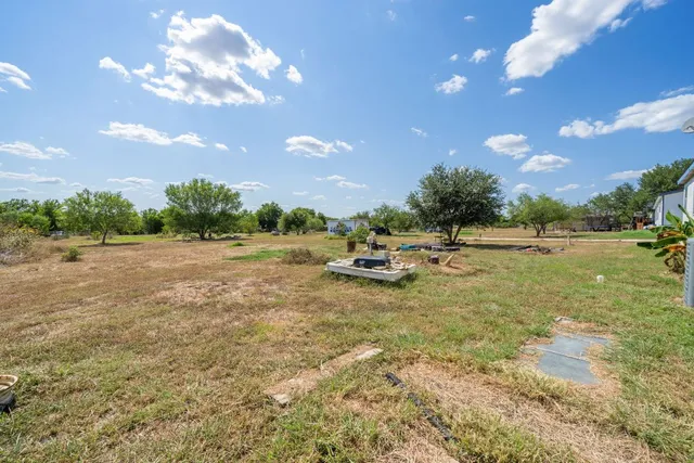 a view of yard with swimming pool and green space