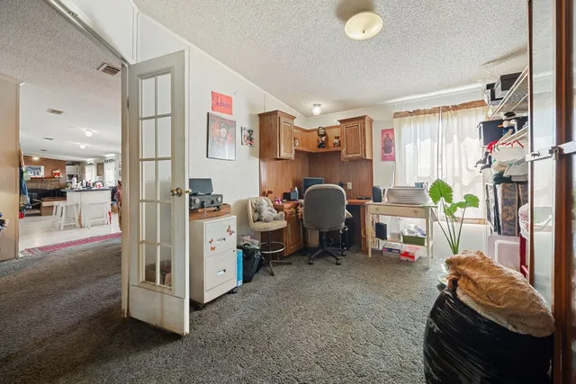 a view of livingroom with workspace and a window