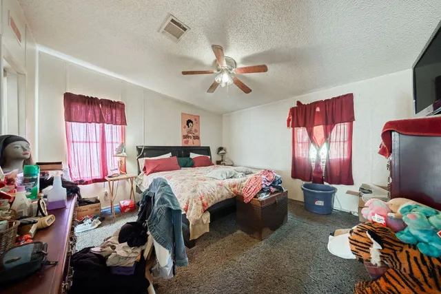 a bedroom with bed furniture and a window
