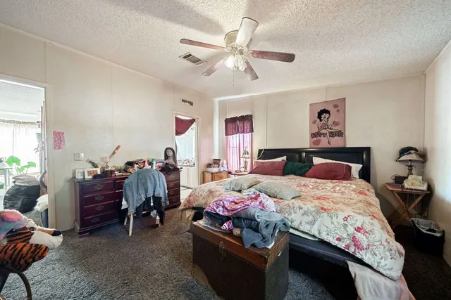 a bedroom with bed and a chandelier