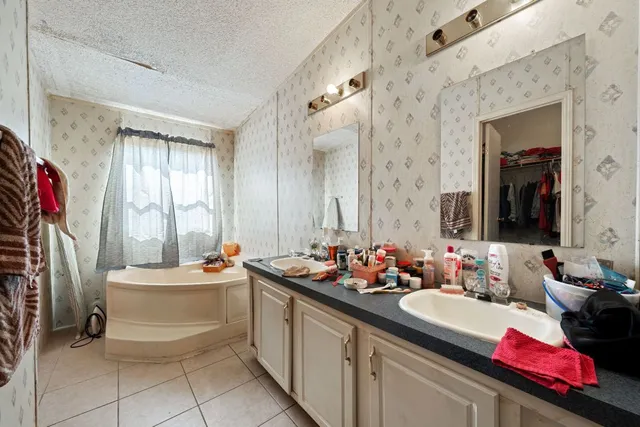 a bathroom with a sink mirror and a bathtub
