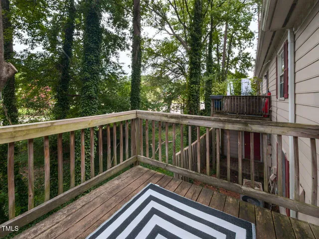 a view of balcony with wooden floor and fence