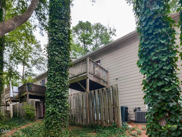 a view of a wooden house with a large trees