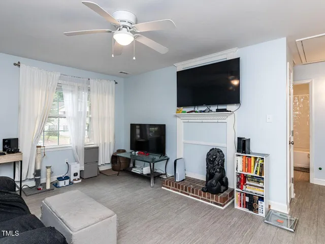 a living room with a flat screen tv and a fireplace