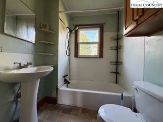 a bathroom with a sink toilet bathtub and vanity