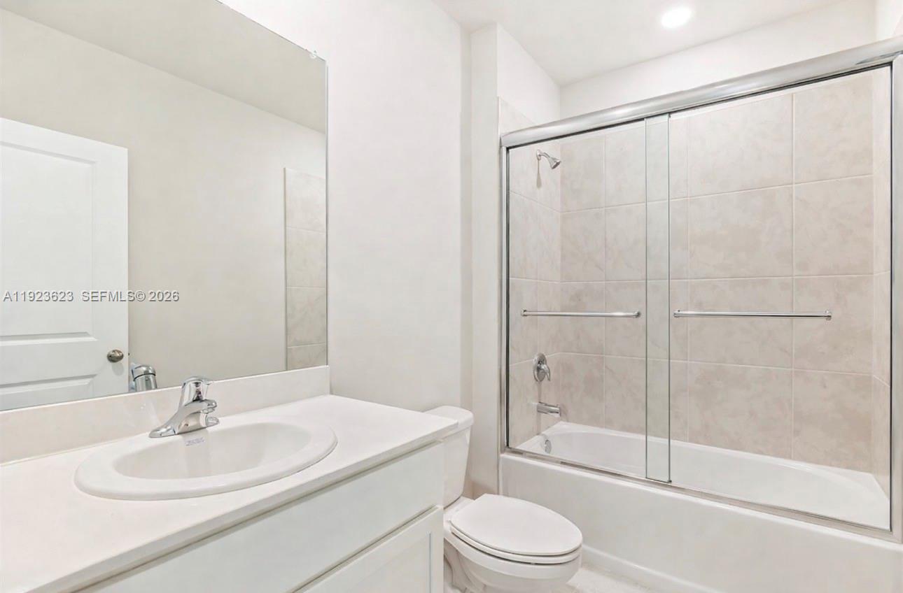 3021 North Lakewood Road LaBelle, FL 33935 - Photo 12 of 13 a bathroom with a white toilet sitting next to a bathroom sink