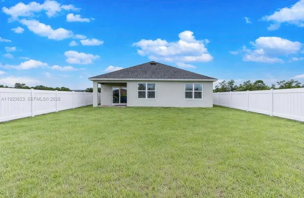 a view of a house with a backyard