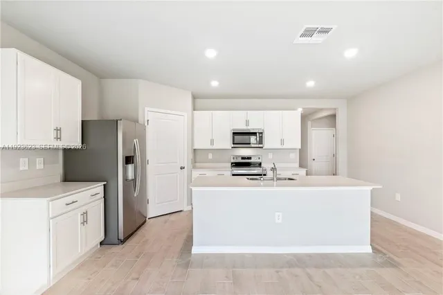 a kitchen with stainless steel appliances a refrigerator stove microwave and cabinets