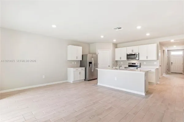 a view of kitchen with wooden cabinet
