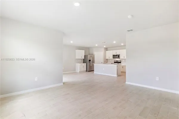 a view of a kitchen with kitchen island and wooden floor