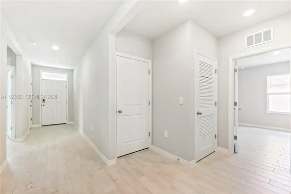 an empty room with windows and closet