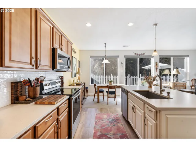 a open kitchen with stainless steel appliances granite countertop a sink and cabinets