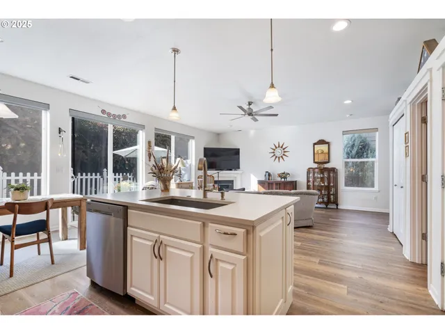 a kitchen with stainless steel appliances kitchen island granite countertop a sink and cabinets
