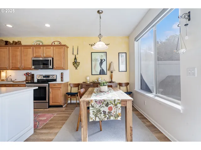 a living room with stainless steel appliances kitchen island granite countertop furniture and a view of kitchen