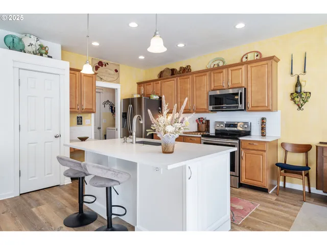 a kitchen with stainless steel appliances kitchen island granite countertop a sink and cabinets