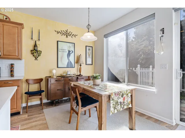 a view of a dining room with furniture and a chandelier