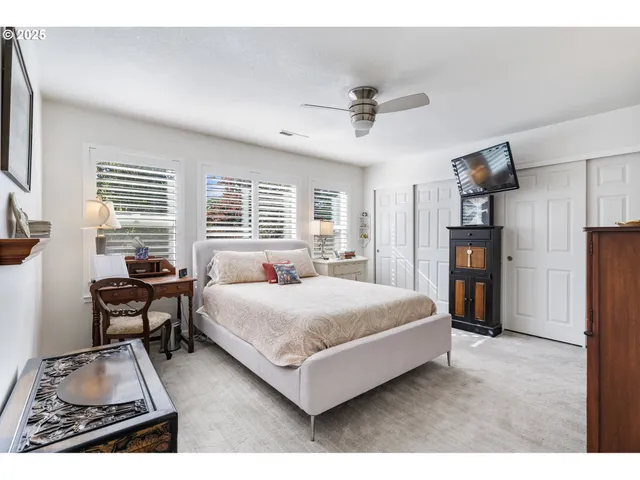 a bedroom with a bed and a table