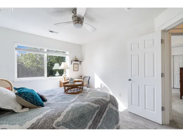 a bedroom with a bed and a large window