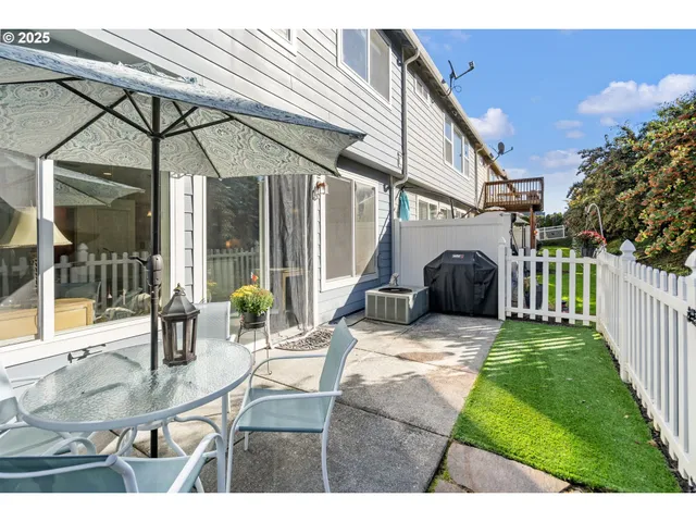 a view of a house with backyard and sitting area