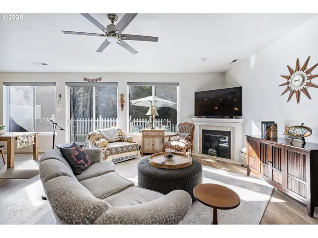 a living room with furniture a flat screen tv and a fireplace