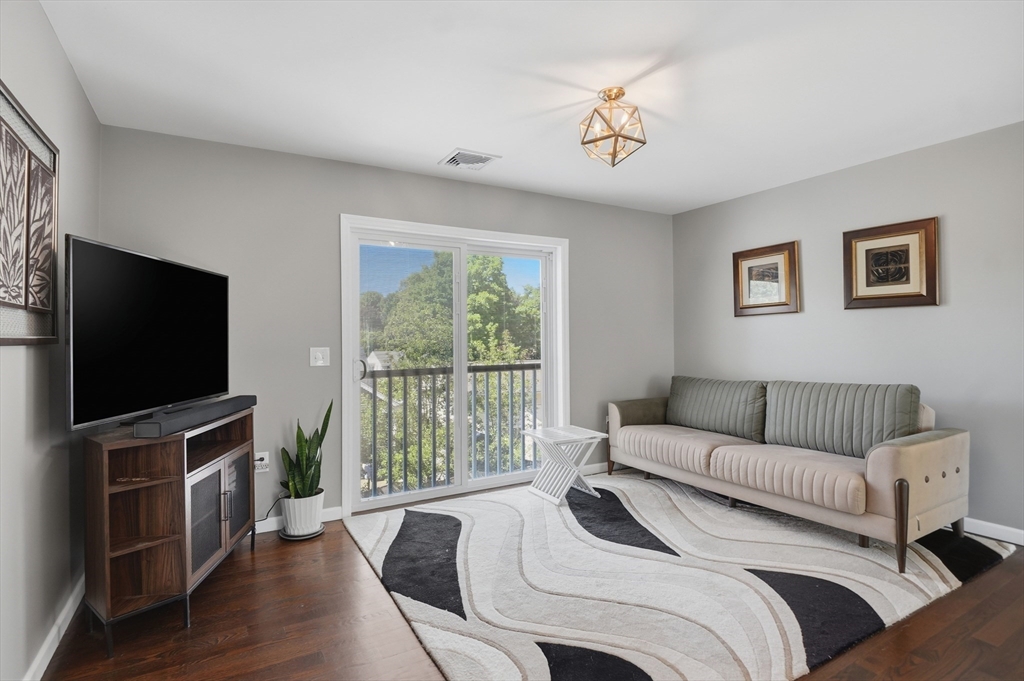 112 Pineland Avenue Worcester, MA 01604 - Photo 18 of 38 a bedroom with a bed and a flat screen tv