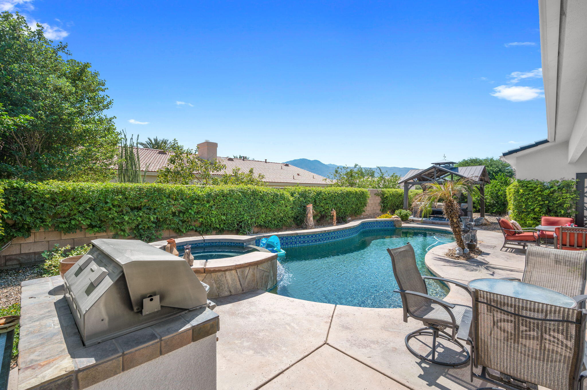 83035 Exeter Court Thermal, CA 92274 - Photo 31 of 38 a view of a patio with couches table and chairs with potted plants and big yard