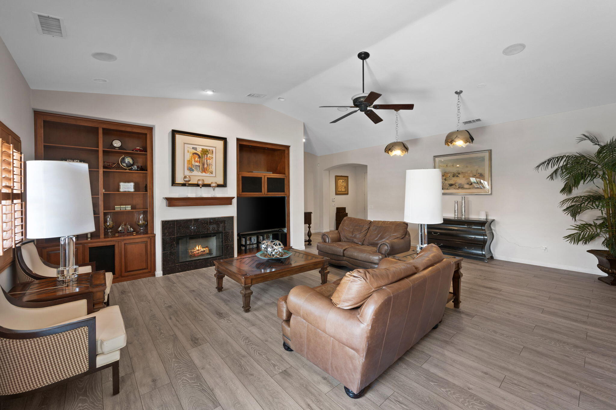 83035 Exeter Court Thermal, CA 92274 - Photo 8 of 38 a living room with fireplace furniture and a wooden floor