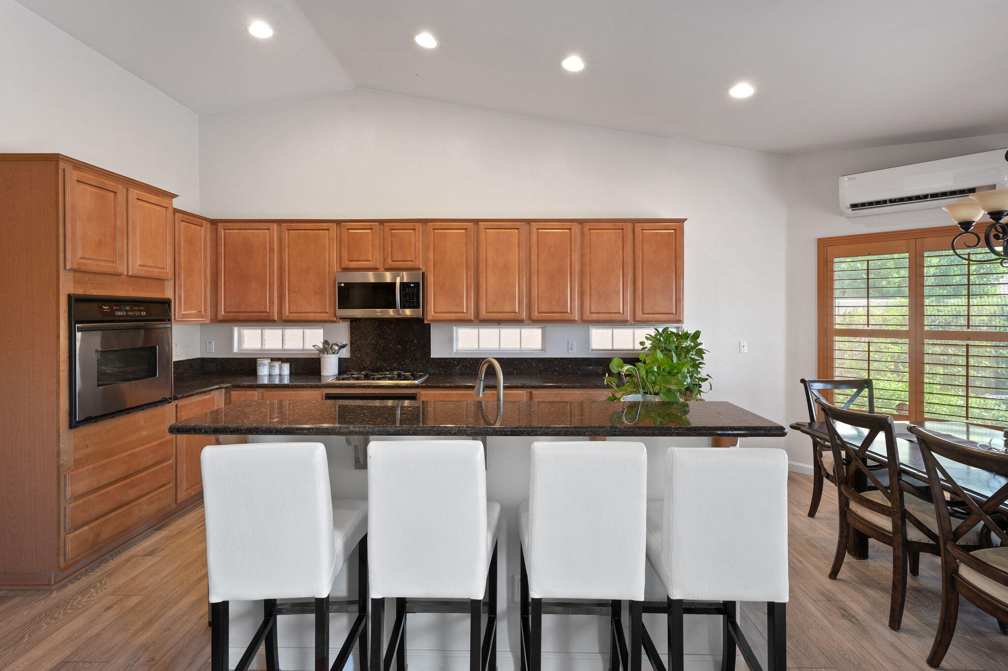 83035 Exeter Court Thermal, CA 92274 - Photo 10 of 38 a kitchen with granite countertop a table chairs microwave and cabinets