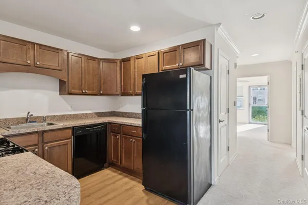a kitchen with a refrigerator and a sink