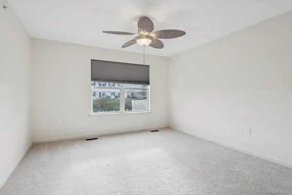 a view of room with window and ceiling fan
