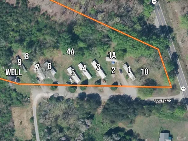 a view of a yard with plants and a fountain