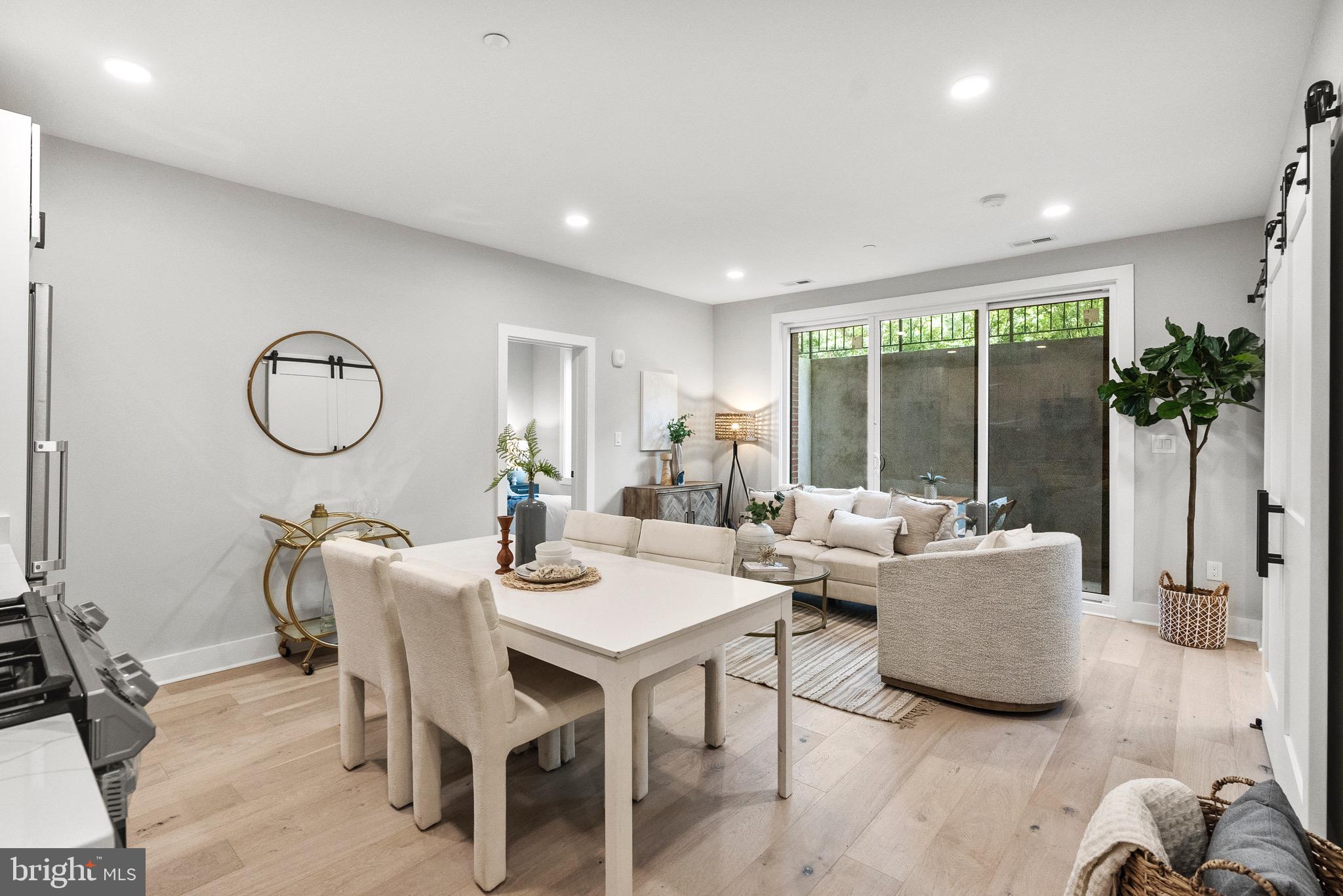 2019 M Street Northeast, Unit 1 Washington, DC 20002 - Photo 6 of 31 a living room with furniture potted plant and a large window