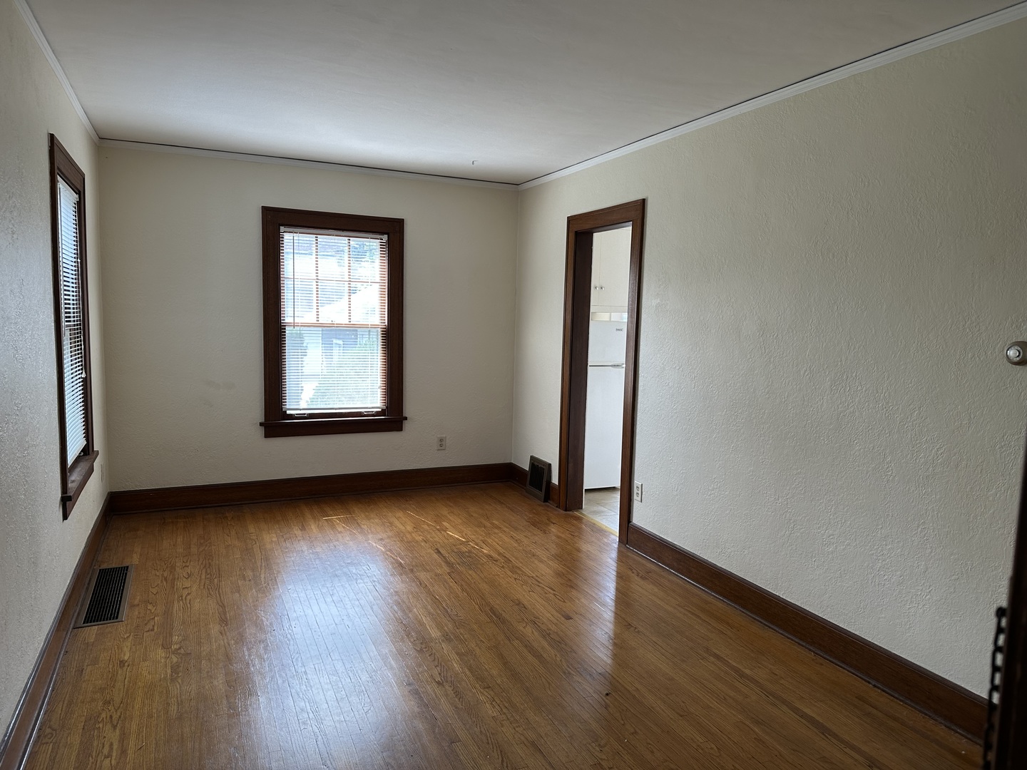206 Oak Street, Unit 1R Elgin, IL 60123 - Photo 5 of 12 an empty room with wooden floor and windows