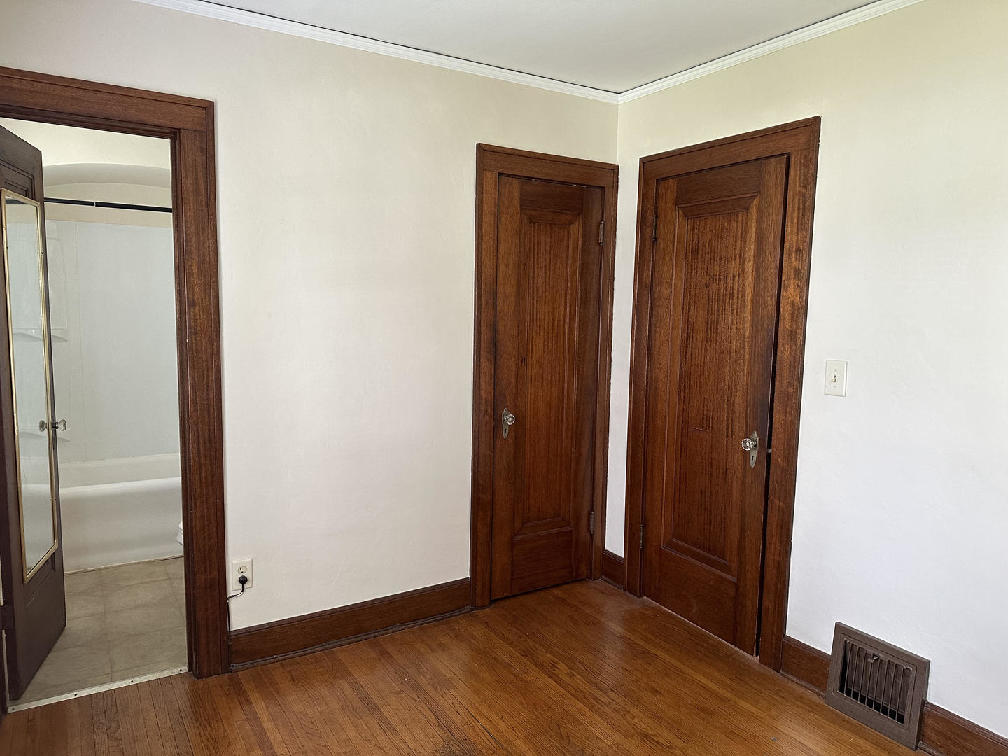 206 Oak Street, Unit 1R Elgin, IL 60123 - Photo 9 of 12 an empty room with wooden floor and windows