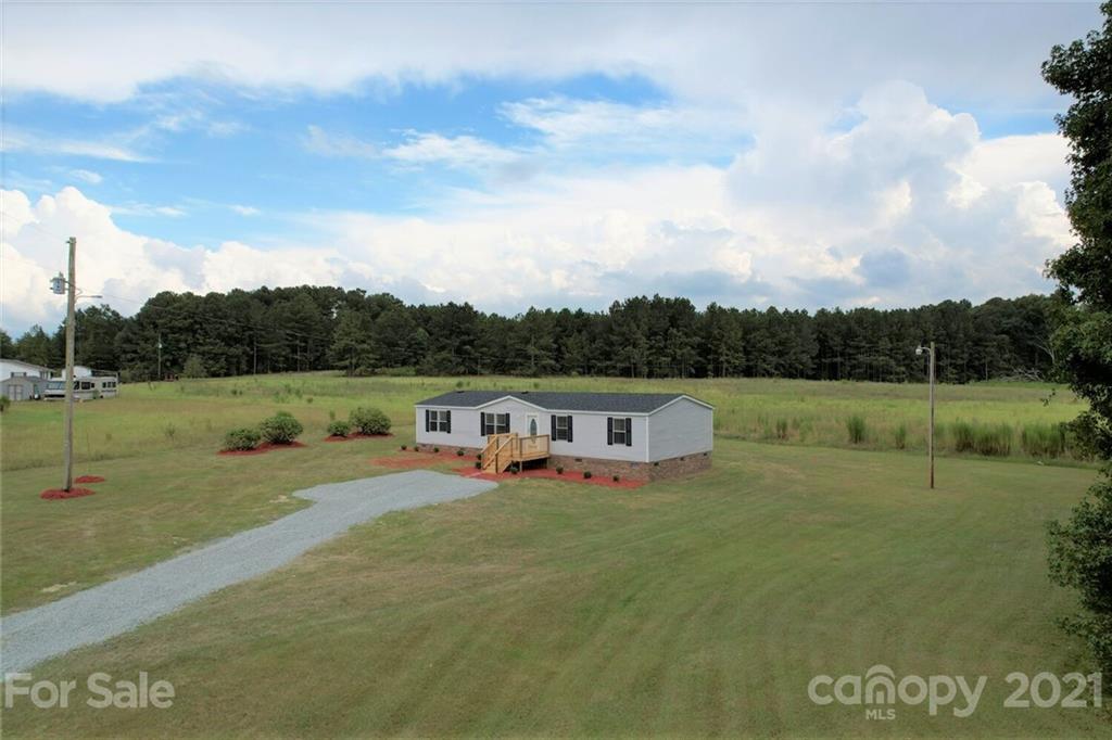 283 Ballard Spring Road, Unit 3276 Morven, NC 28119 - Photo 2 of 48 a view of a lake with a big yard