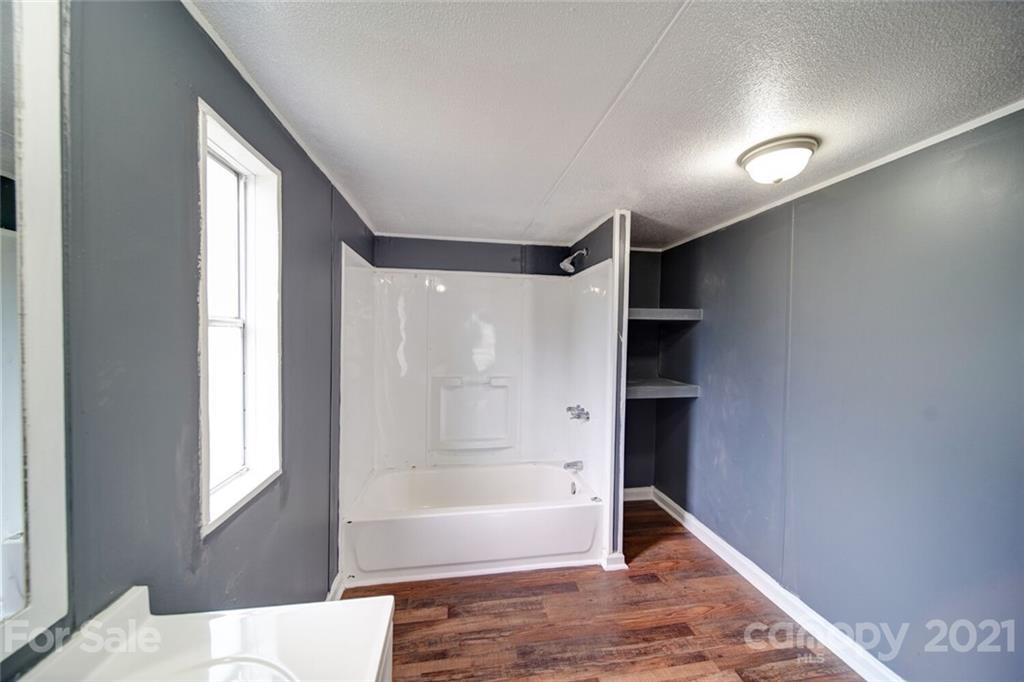 283 Ballard Spring Road, Unit 3276 Morven, NC 28119 - Photo 11 of 48 a bathroom with a bathtub and a shower