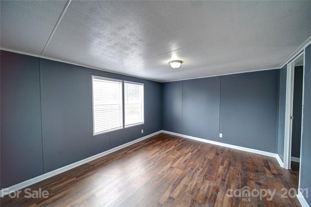 283 Ballard Spring Road, Unit 3276 Morven, NC 28119 - Photo 18 of 48 an empty room with windows