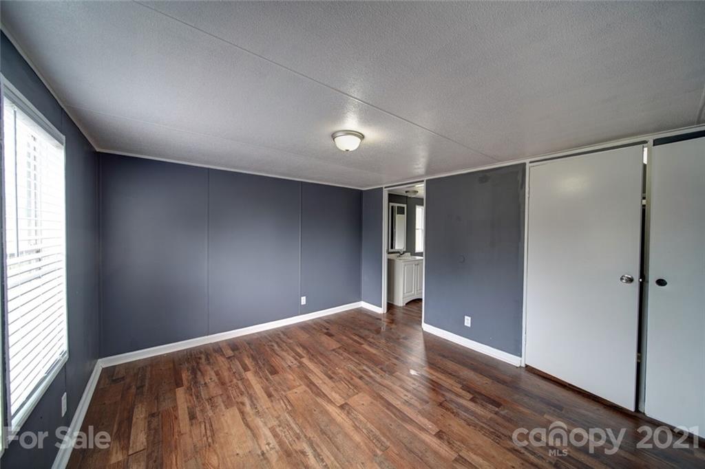 283 Ballard Spring Road, Unit 3276 Morven, NC 28119 - Photo 20 of 48 a view of empty room with wooden floor and fan