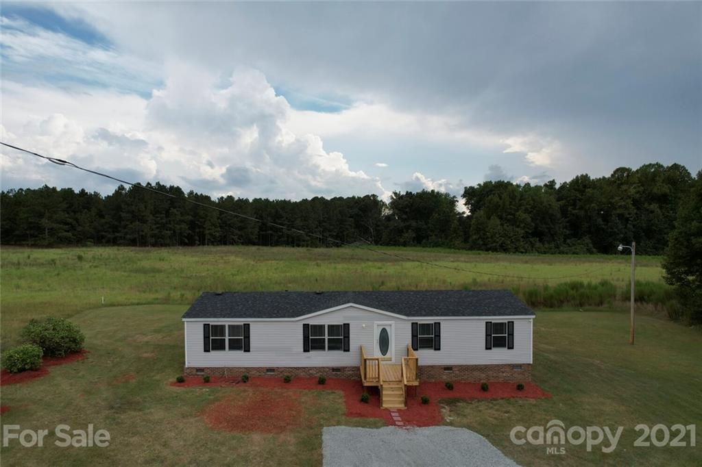 283 Ballard Spring Road, Unit 3276 Morven, NC 28119 - Photo 3 of 48 a view of a house with a yard