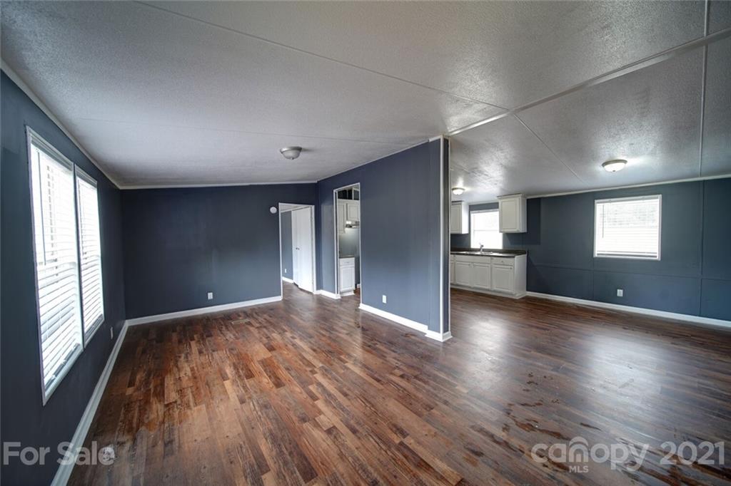 283 Ballard Spring Road, Unit 3276 Morven, NC 28119 - Photo 22 of 48 a view of empty room with wooden floor and fan