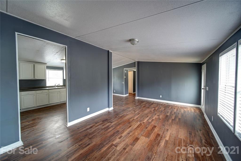 283 Ballard Spring Road, Unit 3276 Morven, NC 28119 - Photo 23 of 48 a view of an empty room with wooden floor and a window
