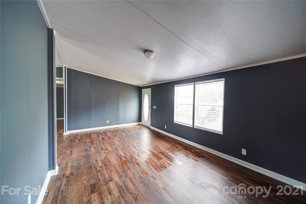 283 Ballard Spring Road, Unit 3276 Morven, NC 28119 - Photo 24 of 48 a view of an empty room with wooden floor and a window