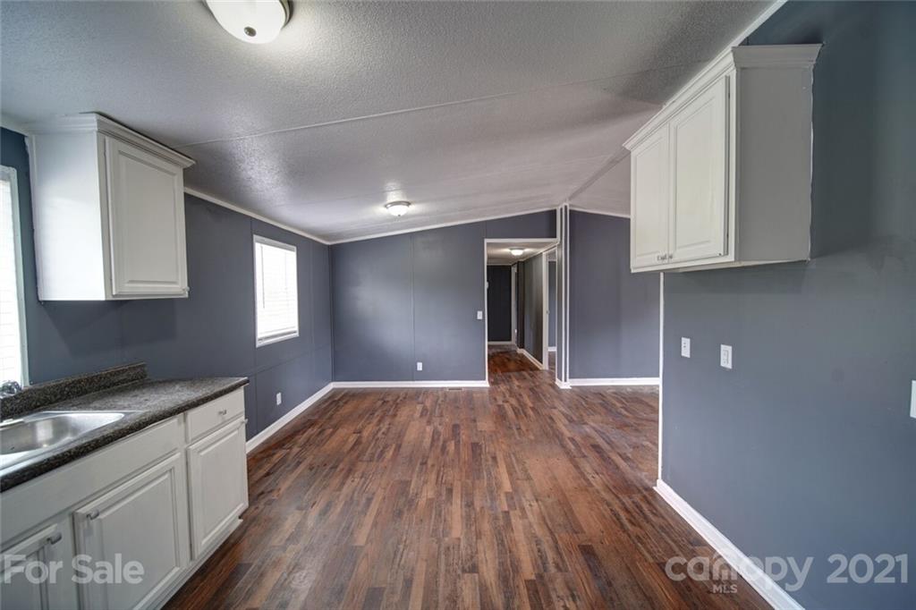 283 Ballard Spring Road, Unit 3276 Morven, NC 28119 - Photo 26 of 48 a view of empty room with wooden floor and cabinets