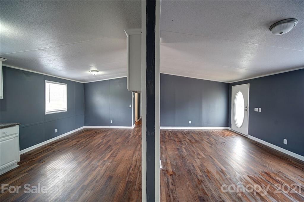 283 Ballard Spring Road, Unit 3276 Morven, NC 28119 - Photo 27 of 48 a view of wooden floor and windows in a room