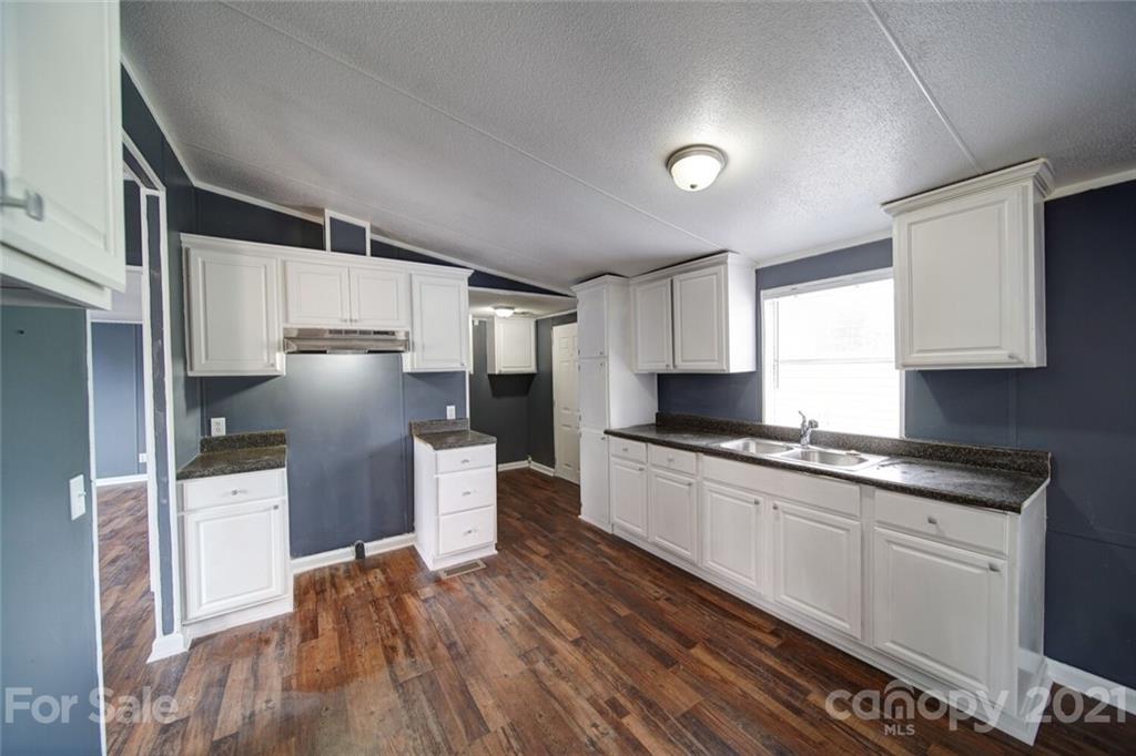 283 Ballard Spring Road, Unit 3276 Morven, NC 28119 - Photo 29 of 48 a kitchen with stainless steel appliances a refrigerator and a stove top oven